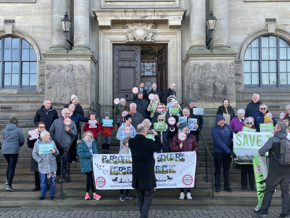 Reidents of Fellgate holding up signs saying save our green belt