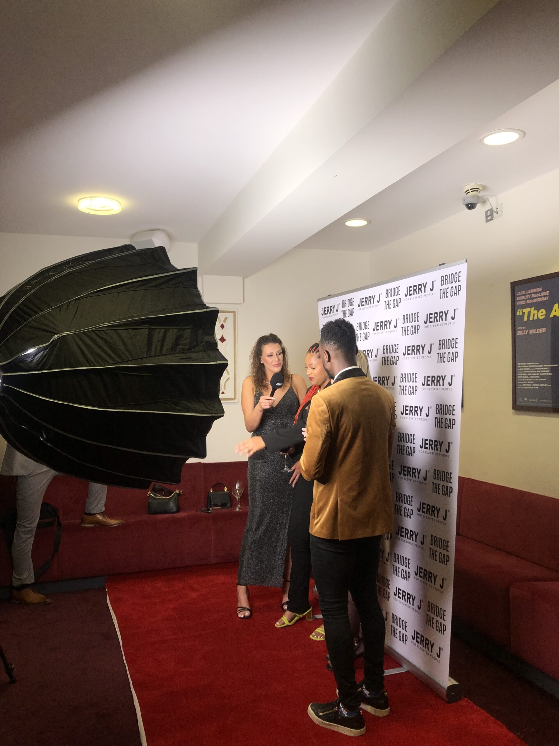Someone being interviewed on a red carpet